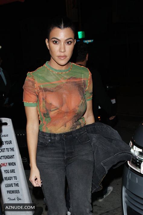 kourtney kardashian wears a see through shirt as she heads