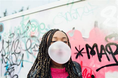 African Young Woman Blowing A Big Bubble Gum By Stocksy Contributor