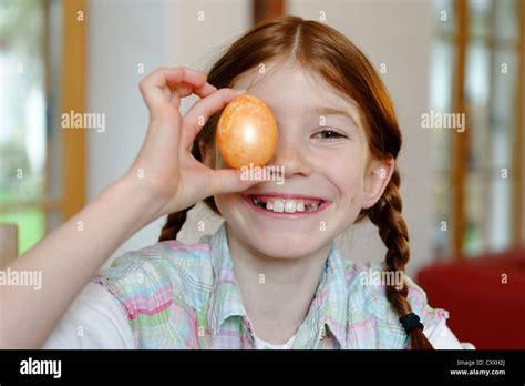 child girl holding  coloured easter egg stock photo alamy
