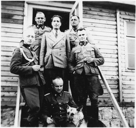 A Group Of Ss Officers Stand On The Steps Of A Building At