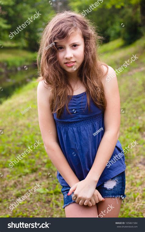 Cute Teenage Girl Looking Shy In Natural Outdoor Setting