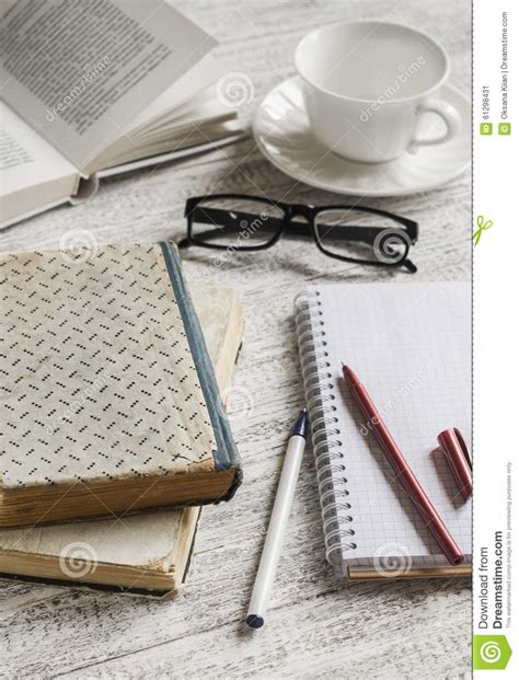 A Stack Of Books Notebook And Glasses Coffee Cup On