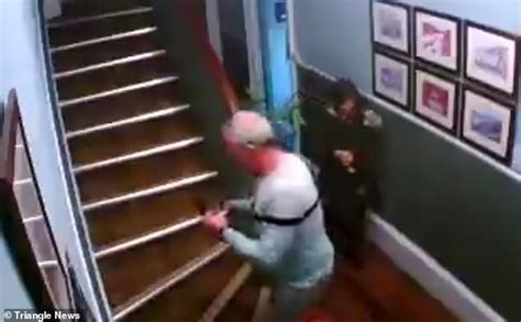 couple caught on camera falling down bandb stairs drinks in hand