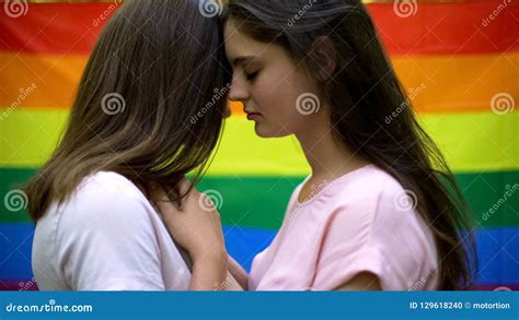 Pretty Lesbians Hugging Lovingly Rainbow Flag On Background Same Sex