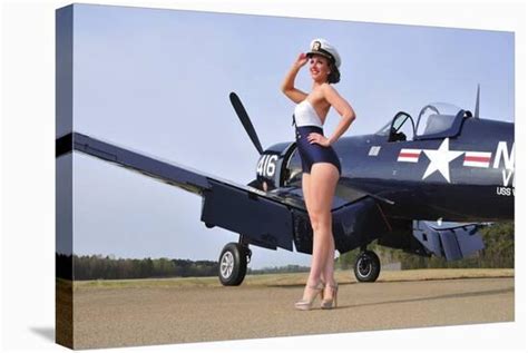 1940s Style Navy Pin Up Girl Posing With A Vintage Corsair Aircraft