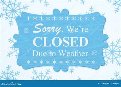 closed due  weather message   wood sign stock image