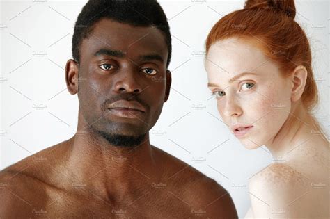 close up shot of black male and white female posing isolated against