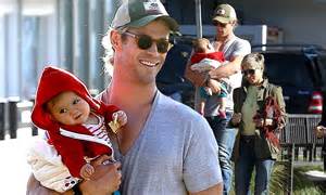 chris hemsworth puts his muscles to good use as he carries