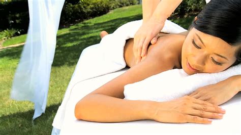 beautiful asian chinese girl enjoying body massage outdoors at a luxury health spa stock footage
