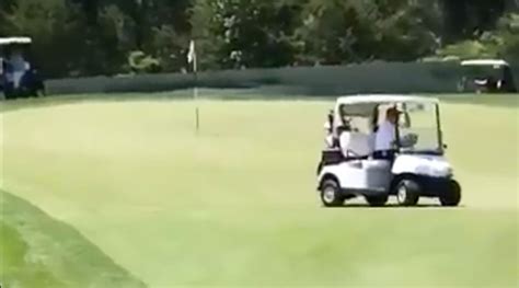 president trump drives cart   bedminster green