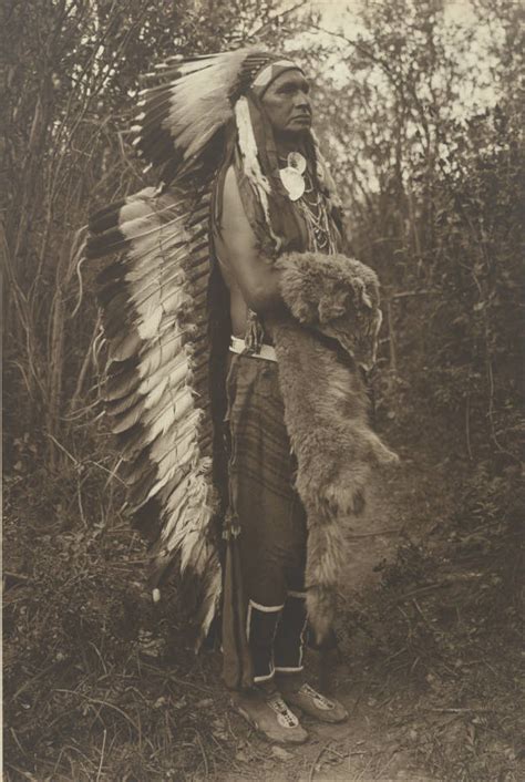 Portrait Of A Native American Man Wearing A Feather