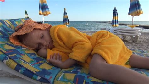 child  girl sleeping  beach sleepy kid coastline children lifestyle stock footage