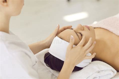 Woman In Spa Receives Head And Facial Massage From Professional Female