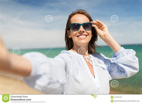 woman in sunglasses taking selfie on summer beach stock image image