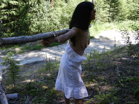 my slut heather crucified and displayed outdoors in the woods
