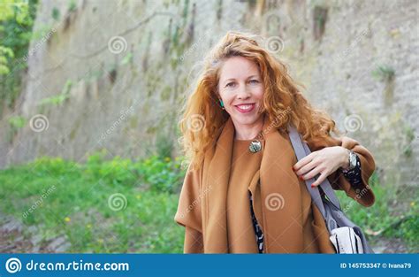 Elegant Attractive Middleaged Woman With Red Curly Hair