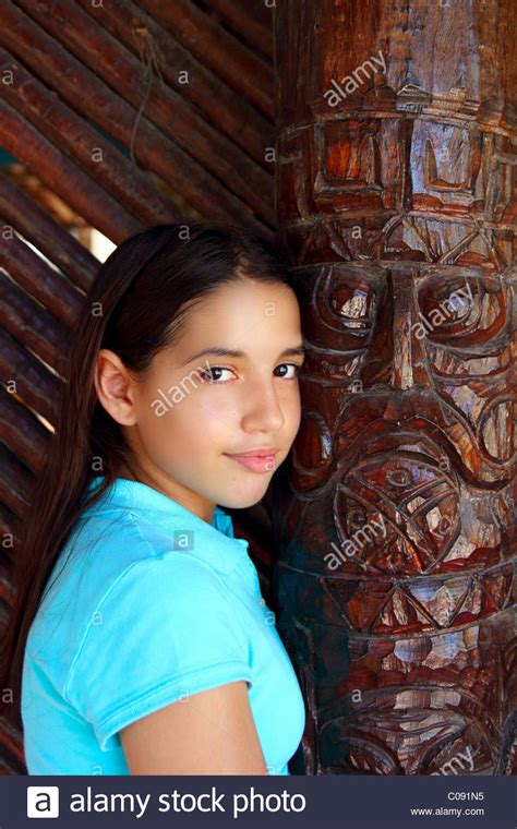 latin mexican teen girl smile with indian wood totem stock