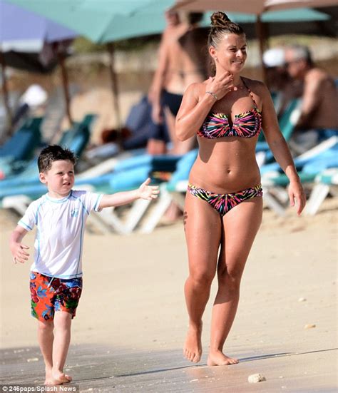 coleen rooney s son kai holds a bottle of beer for a