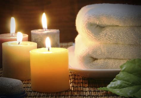 candles  fresh white towels  create  relaxing spa atmosphere