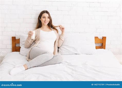 Pregnant Woman Lying On Bed With Glass Of Milk Stock Image Image Of