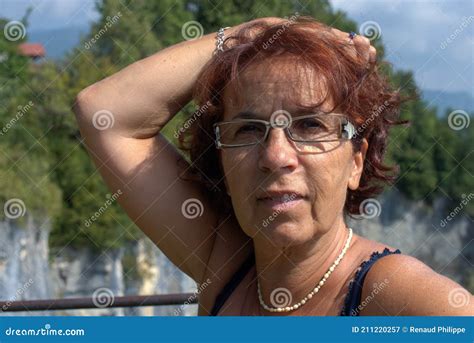Portrait Of Beautiful Tanned Mature Brunette With Eyeglasses Stock
