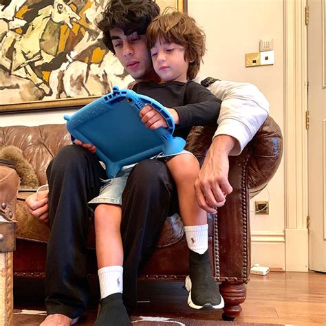 shah rukh khan and aryan khan share cutesy moments with little one abram khan bollywood hungama