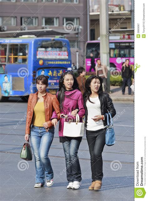 three chinese teenagers on the street editorial