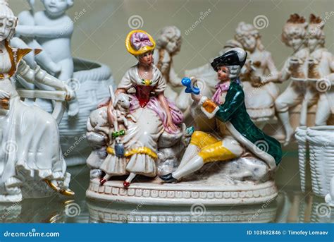 assortment  rare porcelain figurines  glass shelf stock photo