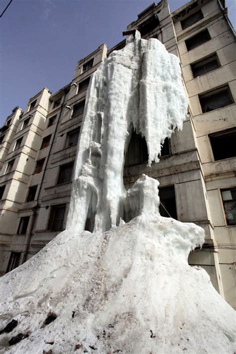 man creates ice waterfall down the side of apartment building by leaving tap water running