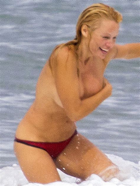 pamela anderson exposes boobs in french beach romp