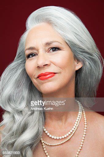 woman with long grey hair wearing pearls bildbanksbilder getty images