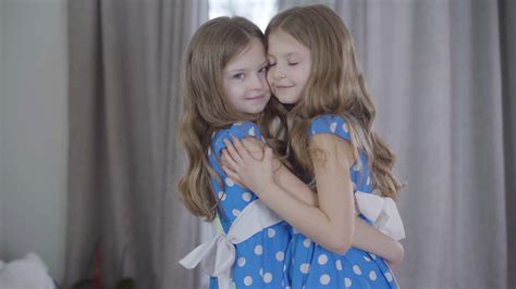 portrait   joyful twin sisters stock footage sbv