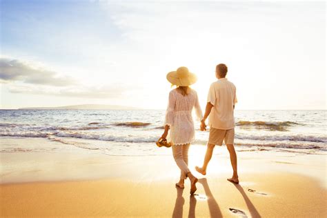 happy romantic middle aged couple enjoying beautiful sunset walk on the
