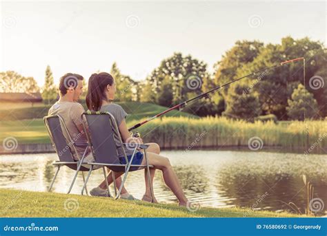 couple catching fish stock photo image  adult park