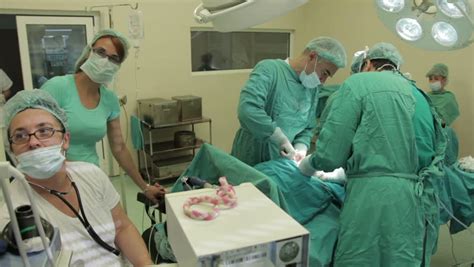 Surgical Team Performing Caesarean Section In Operation