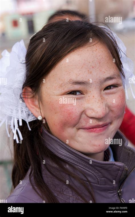 Mongolian Girl With Fair Skin And Freckles Readily Poses In Olgii Stock