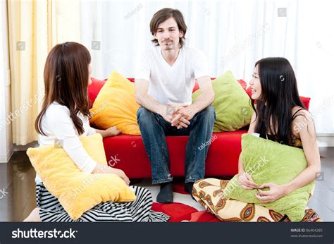 young people talking   living room stock photo