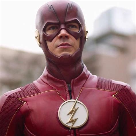 The Flash Standing In Front Of A Building With His Head Turned To Look