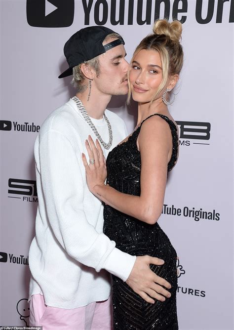 justin bieber can t keep his hands and lips off wife hailey as he