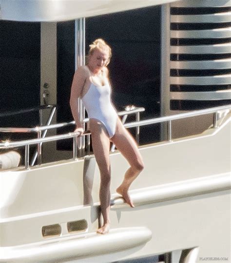 Sophie Turner Caught Relaxing In Sexy White Swimsuit