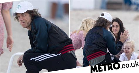Mick Jagger Recuperates On Beach As He Postpones Rolling Stones Tour