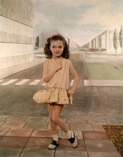 kindermode atelierfotografie meisje poseert met damestasje met afbeeldingen
