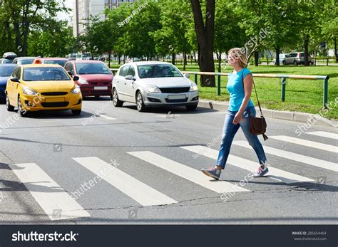 woman crossing  street   pedestrian crossing stock photo