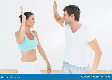 cheerful fit young couple giving high  stock photo image  shape