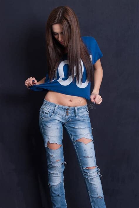 Attractive Woman Wear Blue Crop Top And Ripped Blue Jean Pants Stock