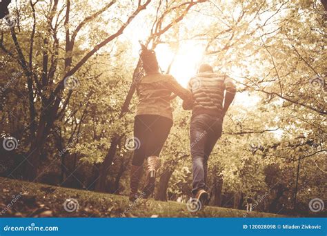 african american couple running  catching  park  stock photo image  park male