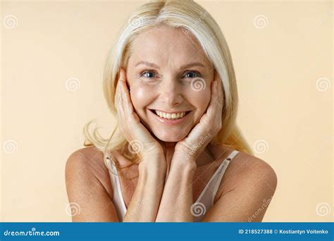 Close Up Portrait Of Natural Mature Woman With Blonde Hair In White