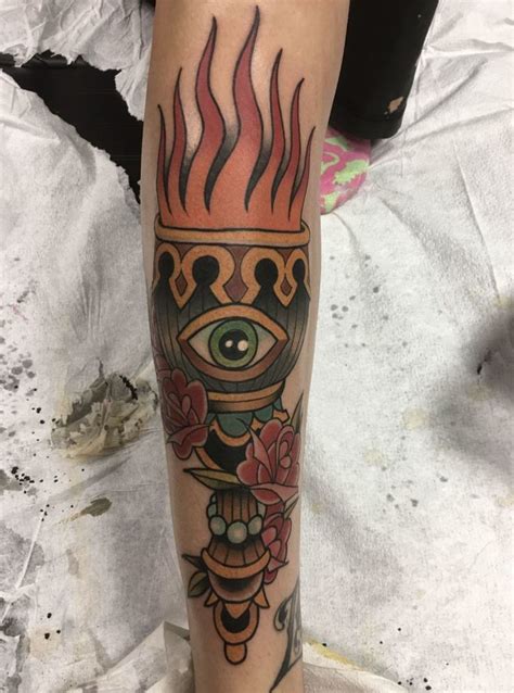 fire torch tattoo meaning and symbolism tattooswin