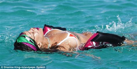 rihanna shows cleavage in barbados with love interest