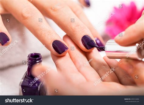 woman   nail manicure   beauty salon   closeup view   beautician applying rich